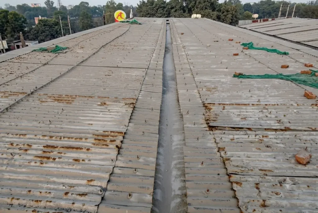 Damaged industrial metal roof before polyurethane waterproofing treatment