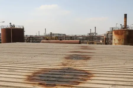 Rusted metal roof before polyurethane coating waterproofing in Pakistan