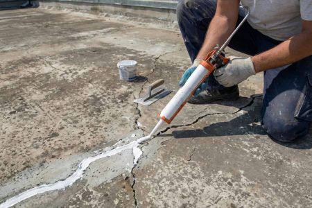 Roof leak repair and crack sealing work on concrete roof before waterproofing application